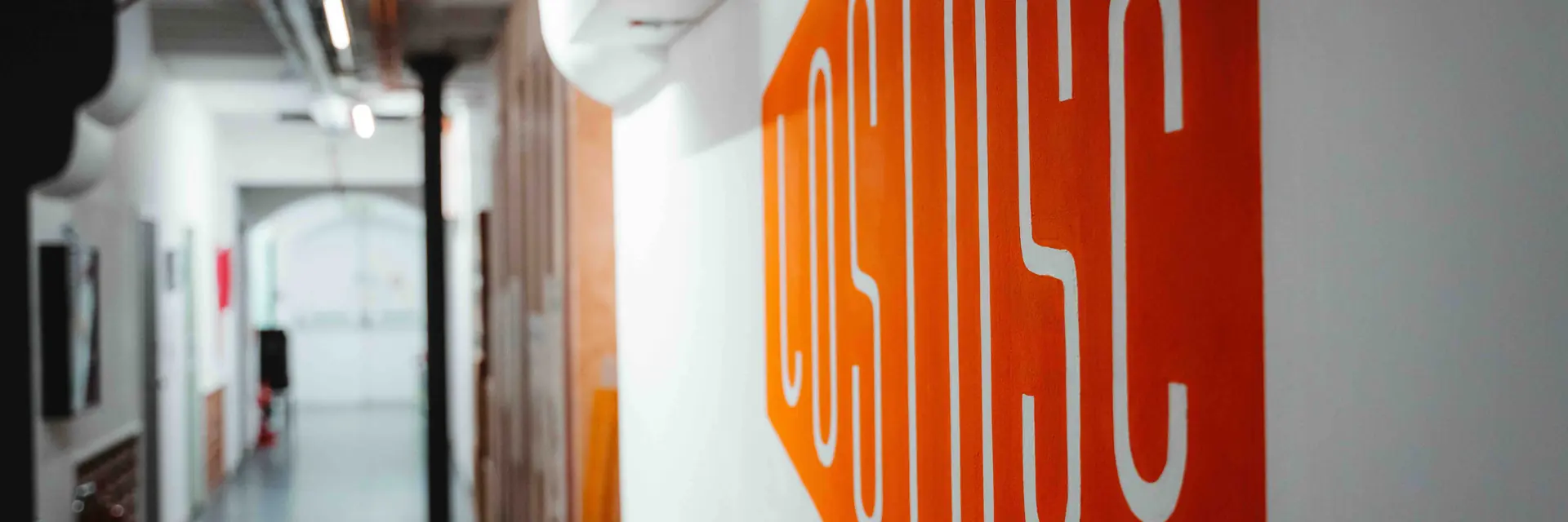 The Lost Oscillation logo painted on the studio corridor wall