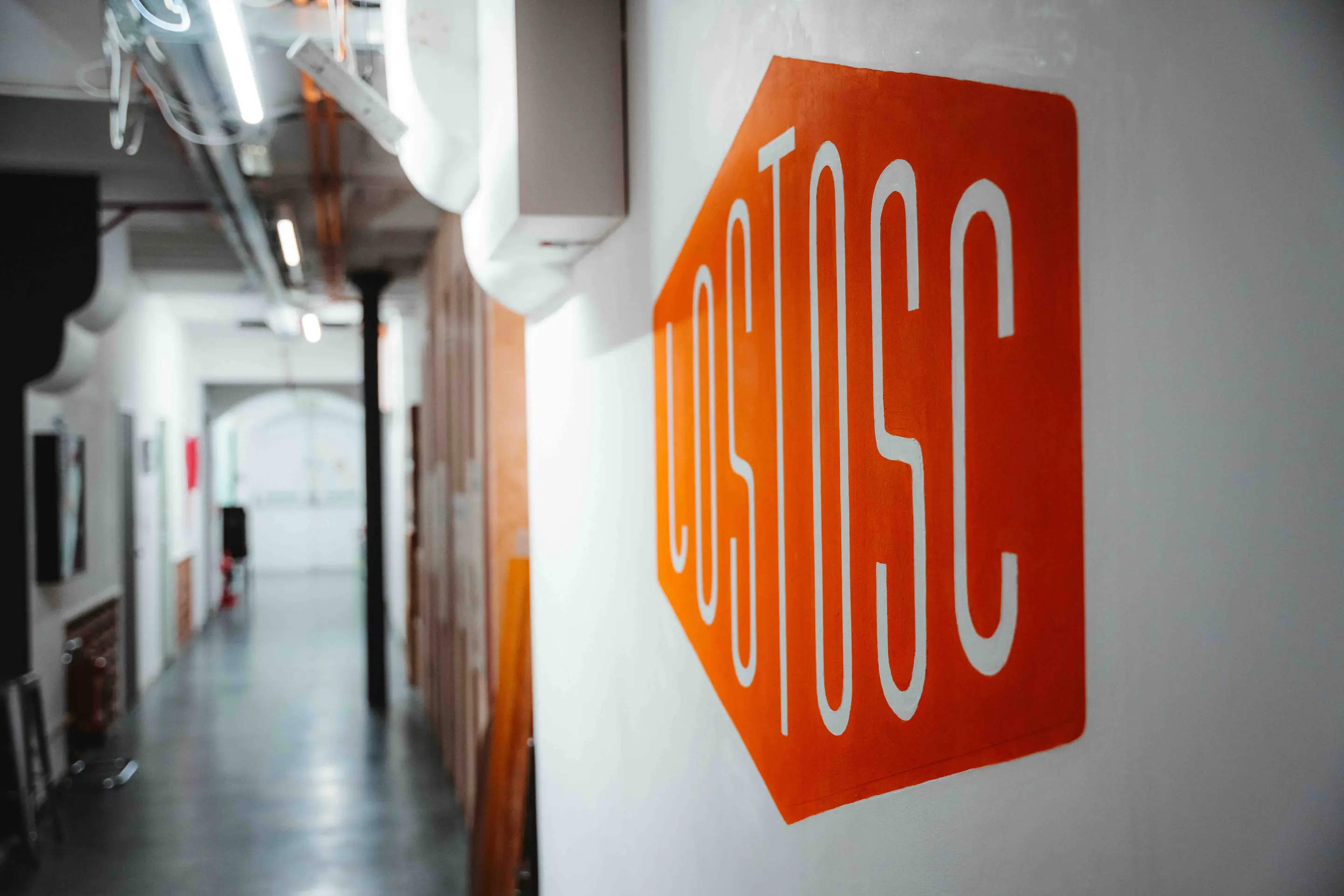 The Lost Oscillation logo painted on the studio corridor wall