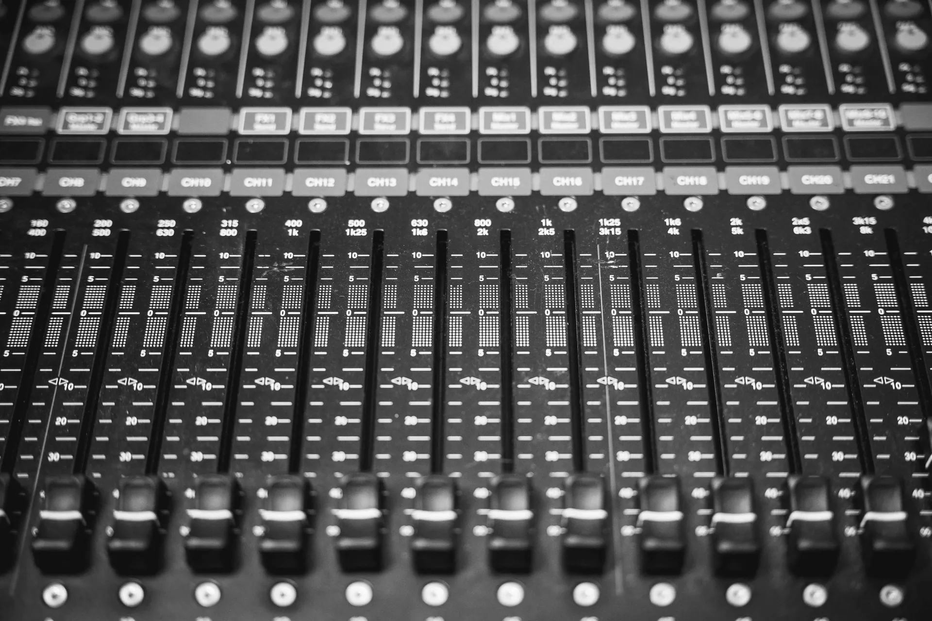 Mixing console faders in black and white